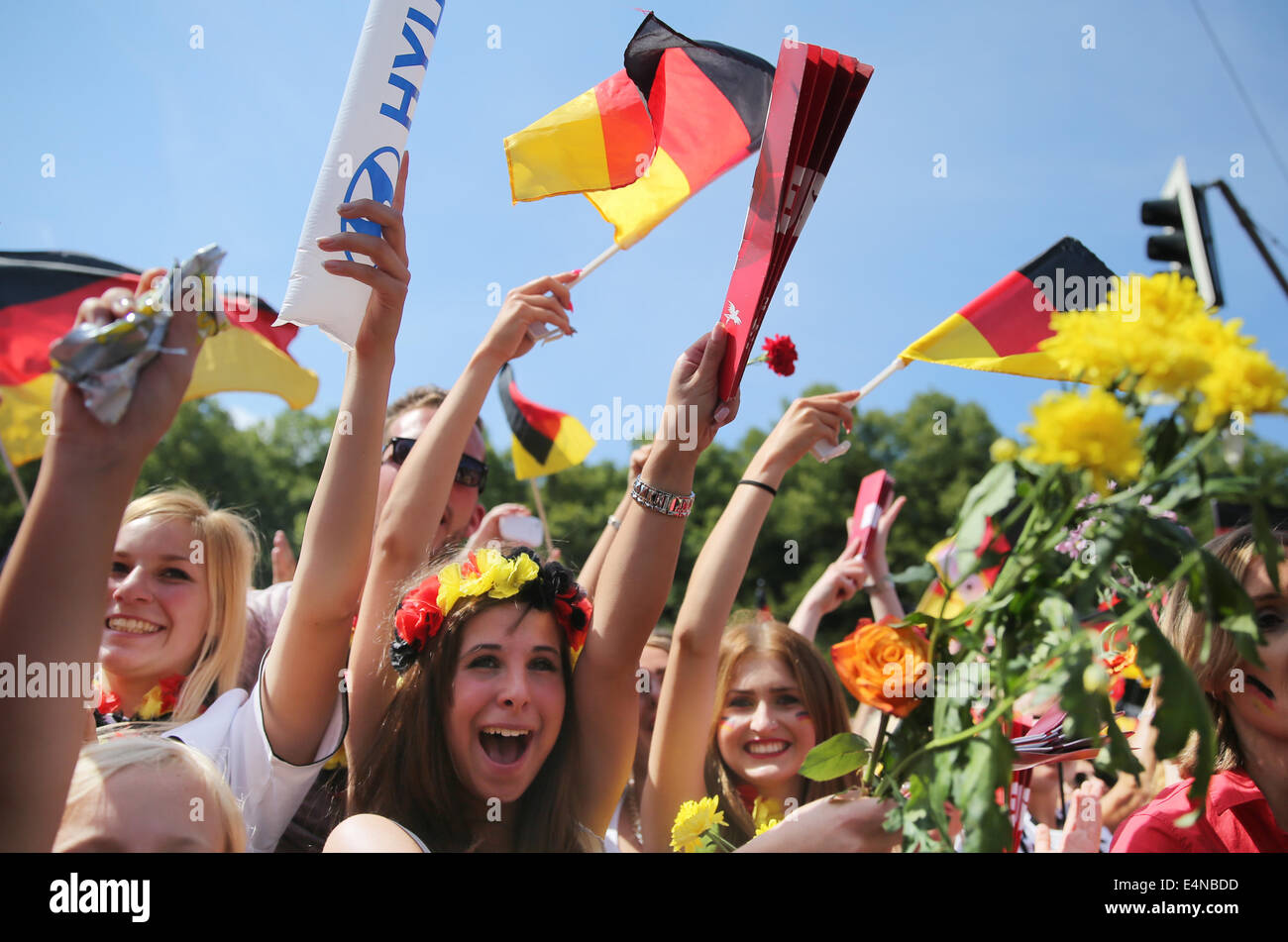 Berlin, Germany. 15th July, 2014. Fans of the German national soccer team celebrate before the reception of the national team at the so-called 'Fan Meile' at Brandenburg Gate in Berlin, Germany, 15 July 2014. The German team on 13 July 2014 had won the Brazil 2014 FIFA Soccer World Cup final against Argentina by 1-0 to win the title for the fourth time after 1954, 1974 and 1990. /Alamy Live News Stock Photo