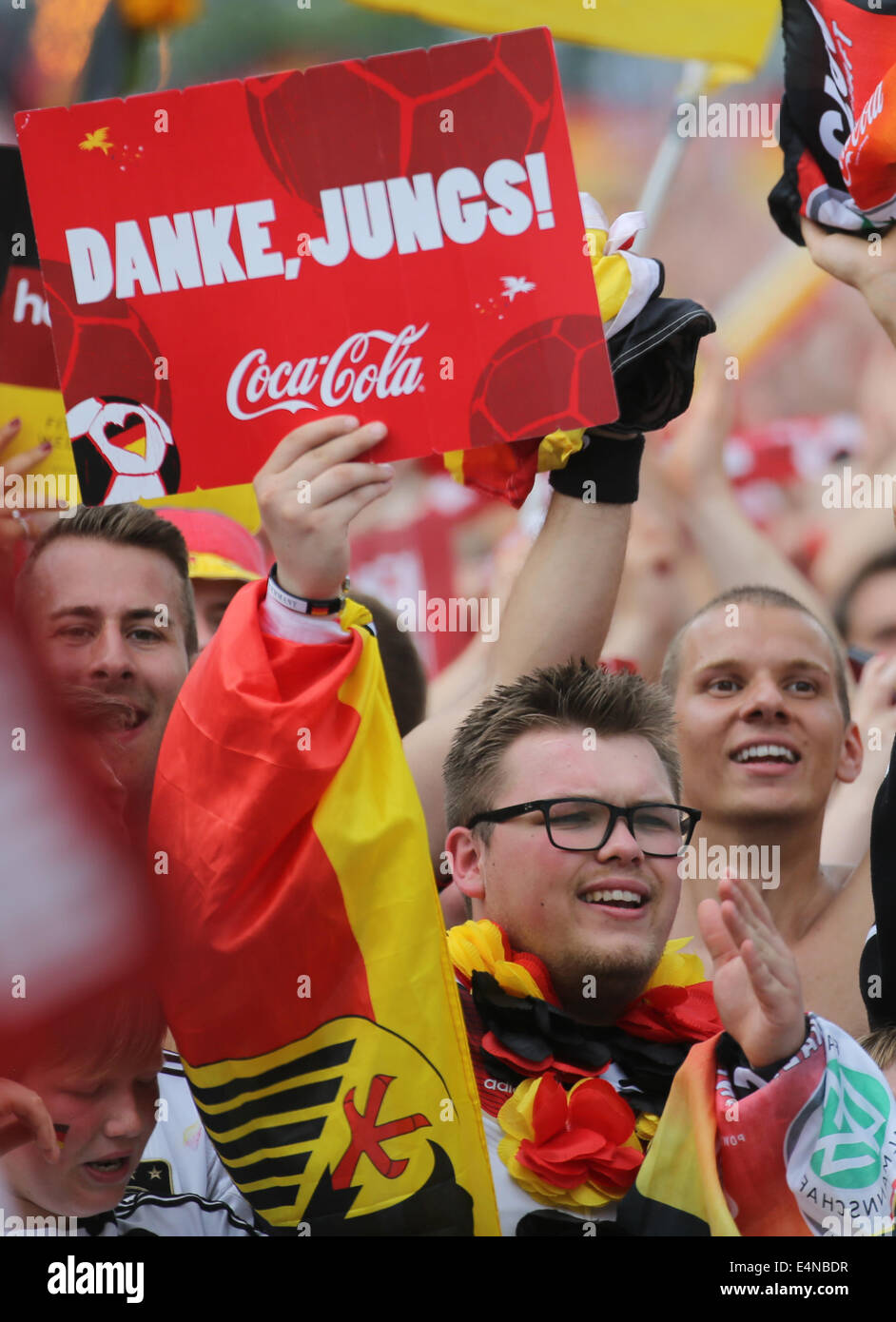 Berlin, Germany. 15th July, 2014. Fans of the German national soccer team celebrate before the reception of the team at the so-called 'Fan Meile' at Brandenburg Gate in Berlin, Germany, 15 July 2014. The German team on 13 July 2014 had won the Brazil 2014 FIFA Soccer World Cup final against Argentina by 1-0 to win the title for the fourth time after 1954, 1974 and 1990. /Alamy Live News Stock Photo