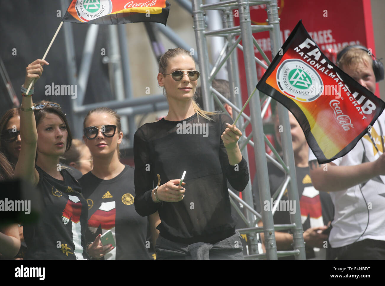 Berlin, Germany. 15th July, 2014. Girlfriend of Sebastian Schweinsteiger, Sara Brandner, holds a German flag at the so-called 'Fan Meile' at Brandenburg Gate in Berlin, Germany, 15 July 2014. The German team on 13 July 2014 had won the Brazil 2014 FIFA Soccer World Cup final against Argentina by 1-0 to win the title for the fourth time after 1954, 1974 and 1990. /Alamy Live News Stock Photo