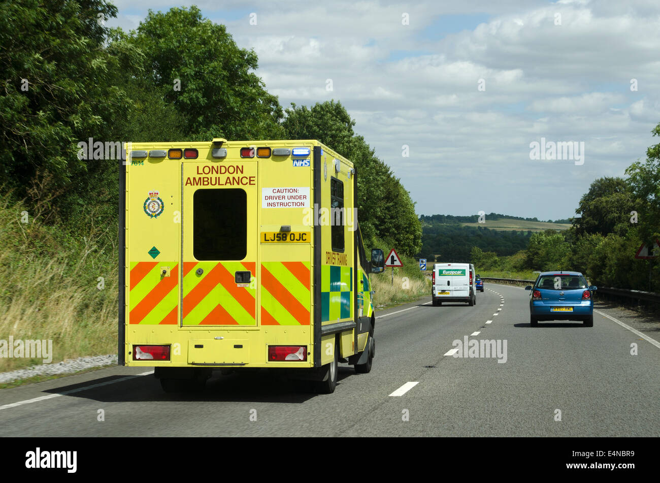 London Ambulance Service driver training vehicle travelling on a blue light along the A303 trunk road in Wiltshire England UK Stock Photo