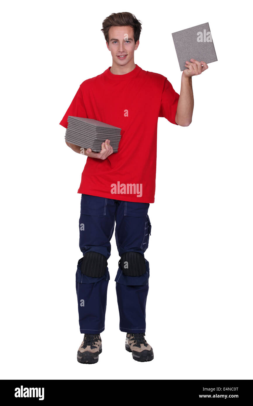 Tradesman holding a stack of tiles Stock Photo