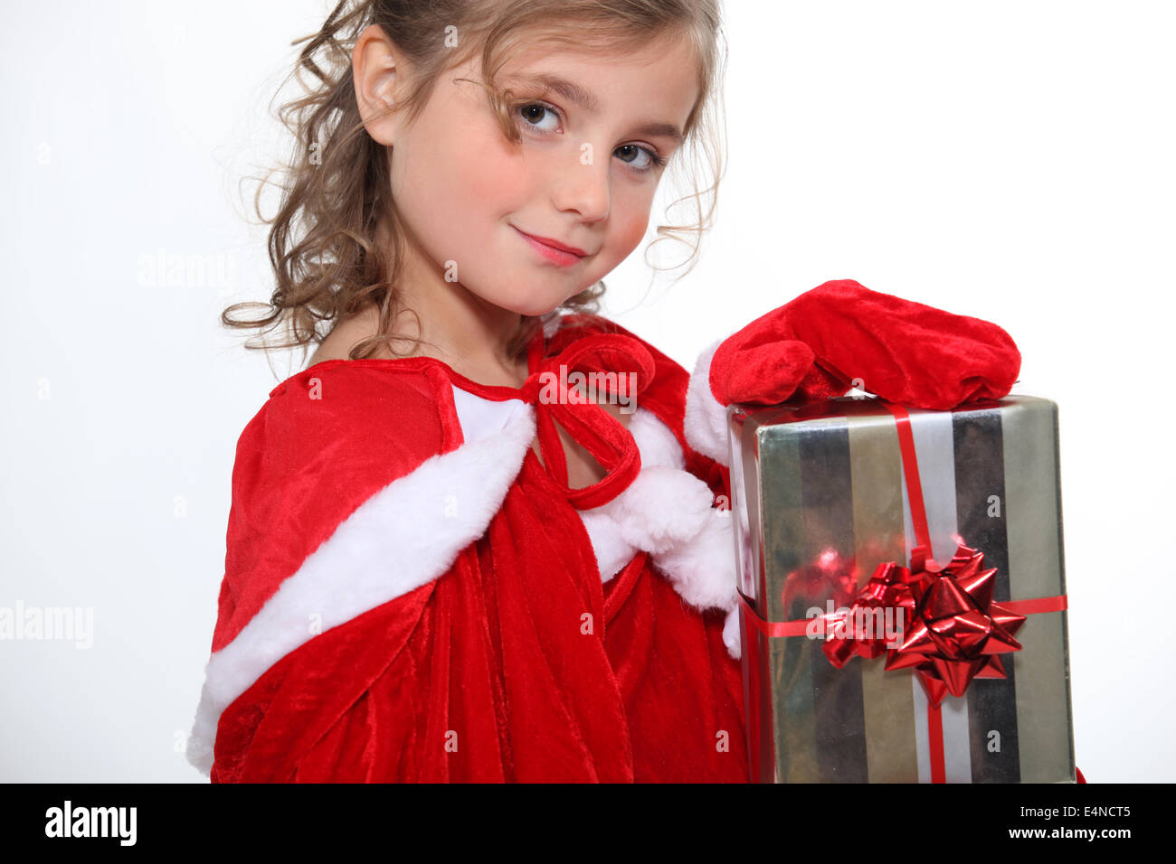 Little girl holding Christmas present Stock Photo - Alamy