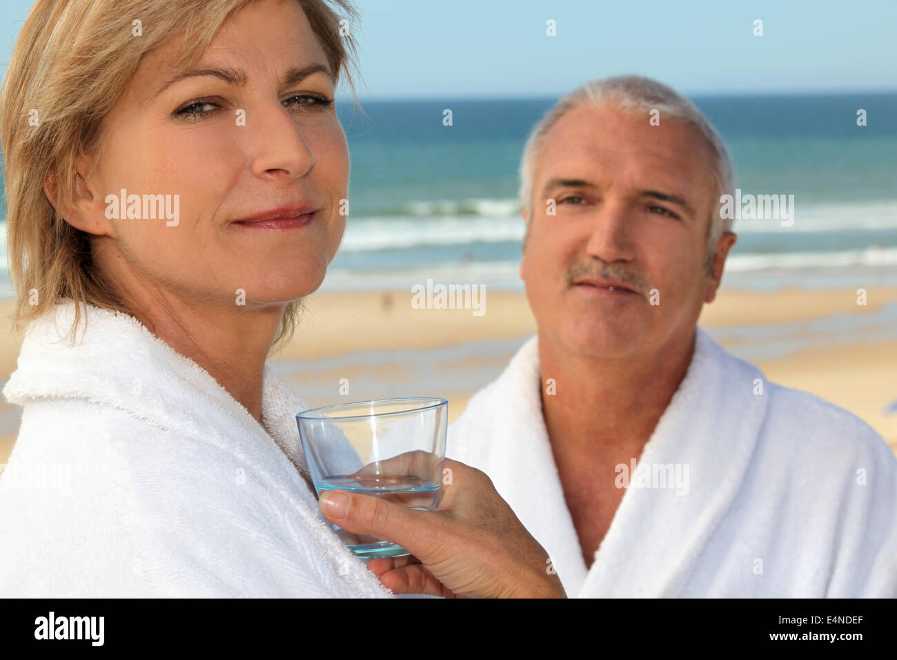 Couple wearing matching robes outdoors Stock Photo Alamy