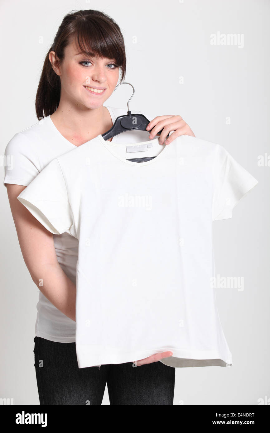 https://c8.alamy.com/comp/E4NDRT/girl-with-a-white-t-shirt-on-a-hanger-E4NDRT.jpg