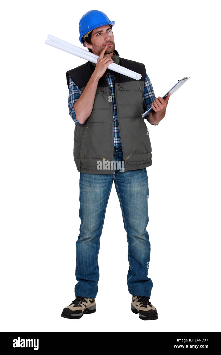 Tradesman weighing his options Stock Photo