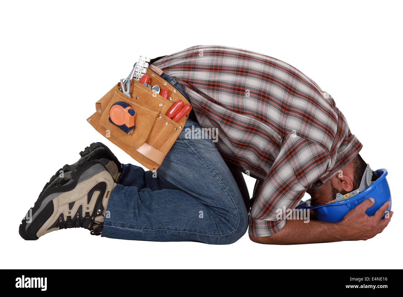 Tradesman with his head in his hands Stock Photo