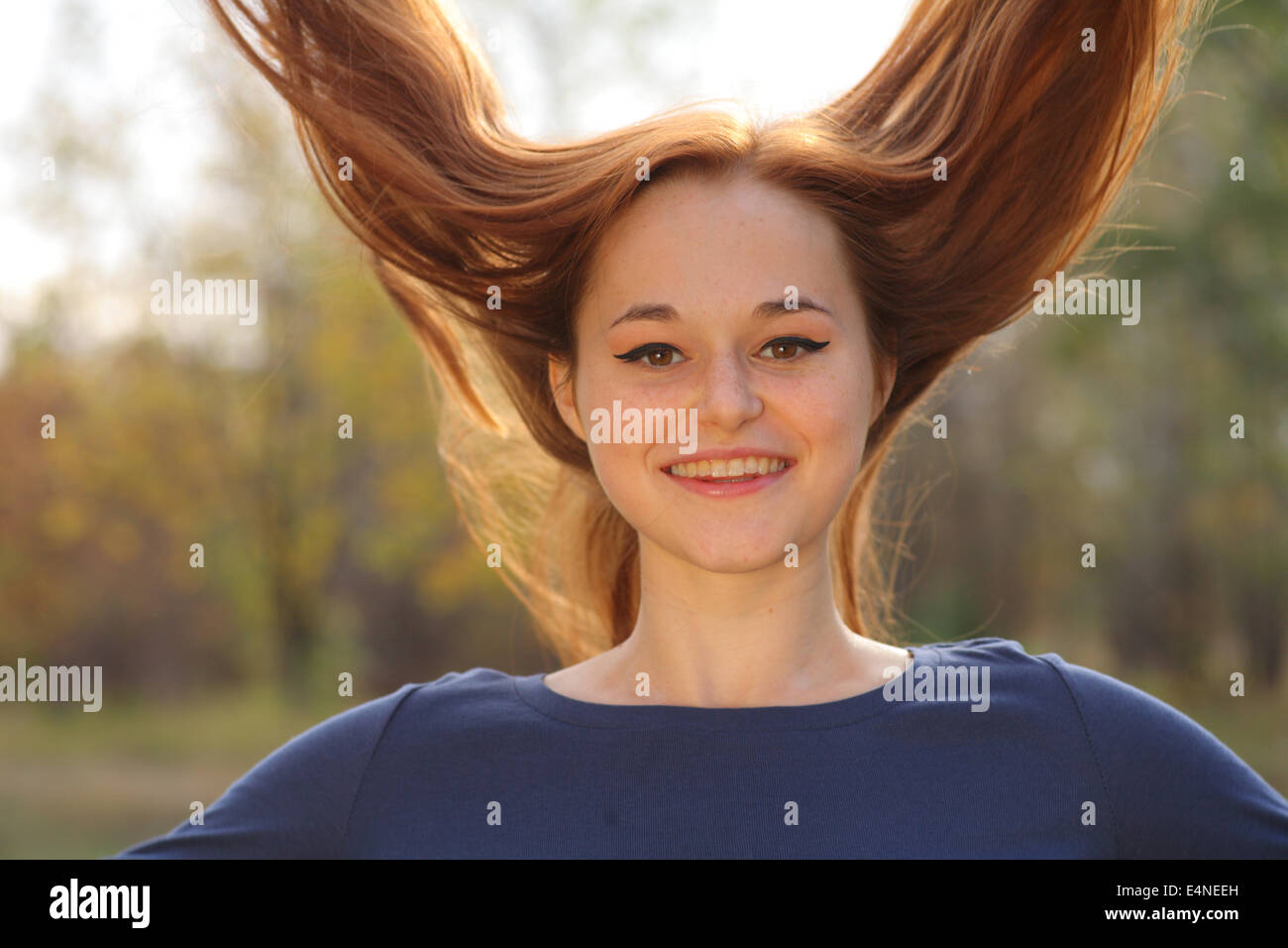Young redhead woman in the park Stock Photo - Alamy