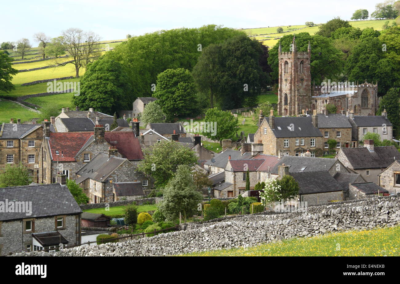 St Giles Church rises above Hartington village in the White Peak, Peak District National Park, Derbyshire, UK - early summer Stock Photo