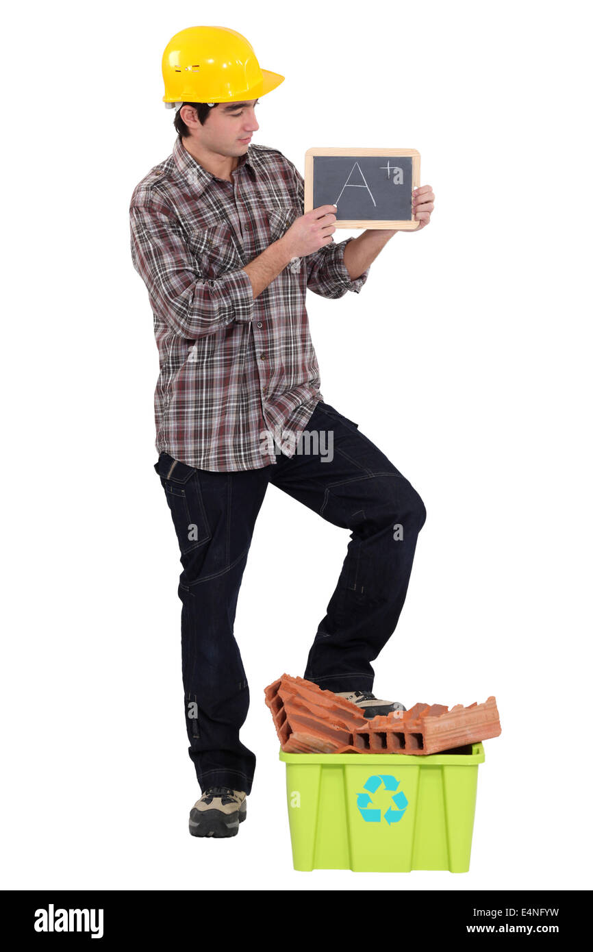 Builder rating his recycling efforts Stock Photo