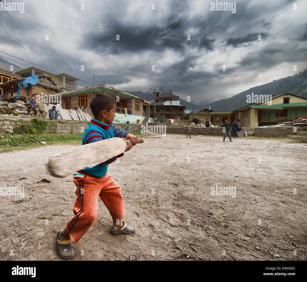 Indian kids playing cricket in a village Stock Photo