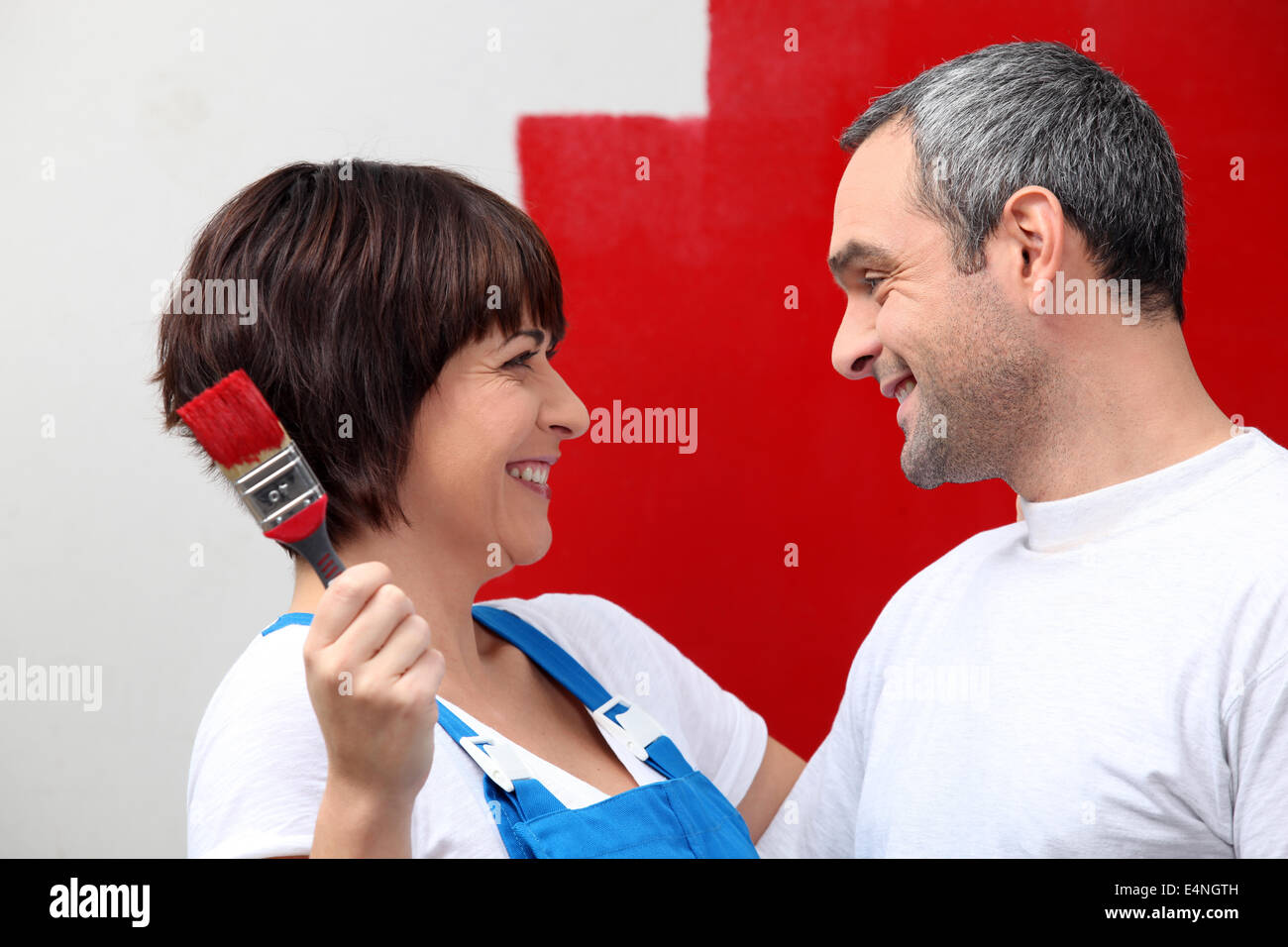 Couple painting wall red Stock Photo