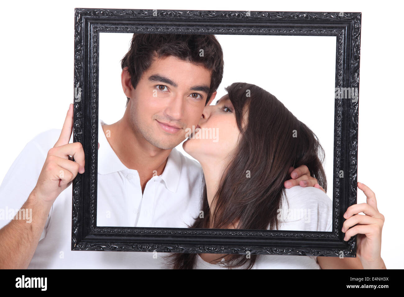 Kissing couple in frame hi-res stock photography and images pic
