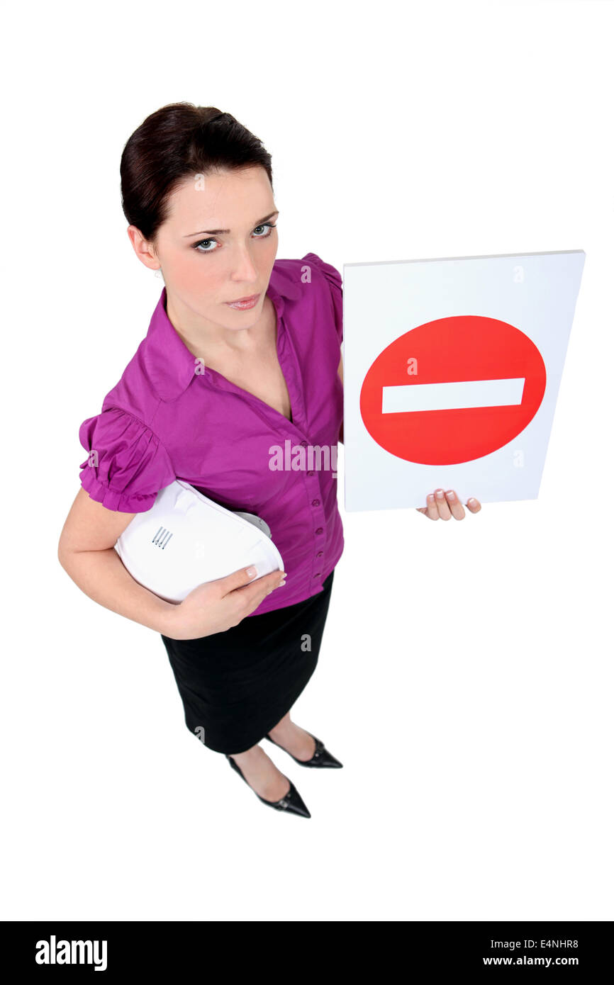 A female architect holding a stop sign. Stock Photo