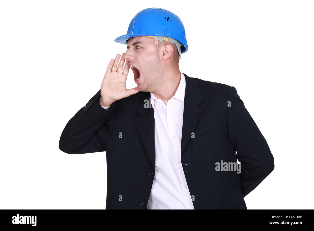 Businessman in a hardhat shouting Stock Photo