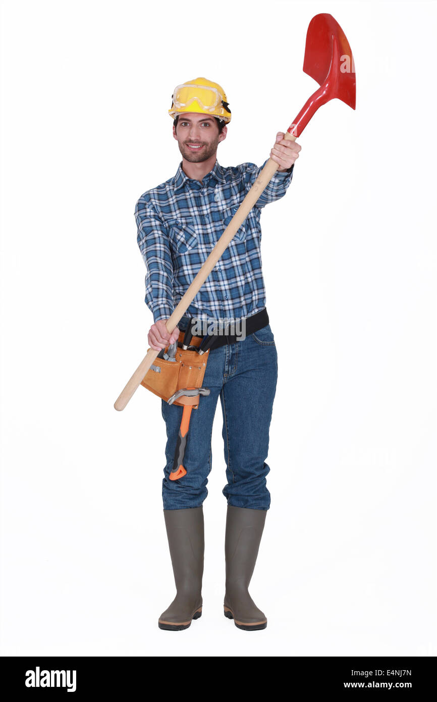 Laborer on white background showing shovel Stock Photo - Alamy