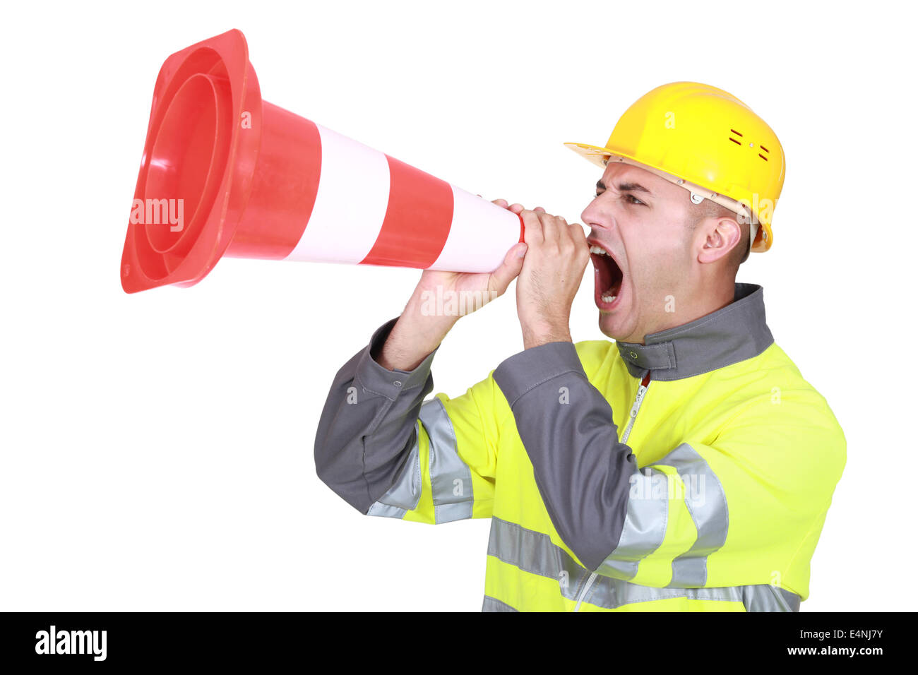 Traffic guard screaming into a pylon Stock Photo