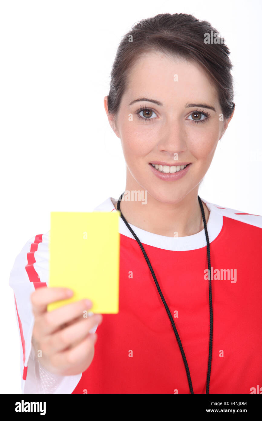Female referee holding yellow card Stock Photo