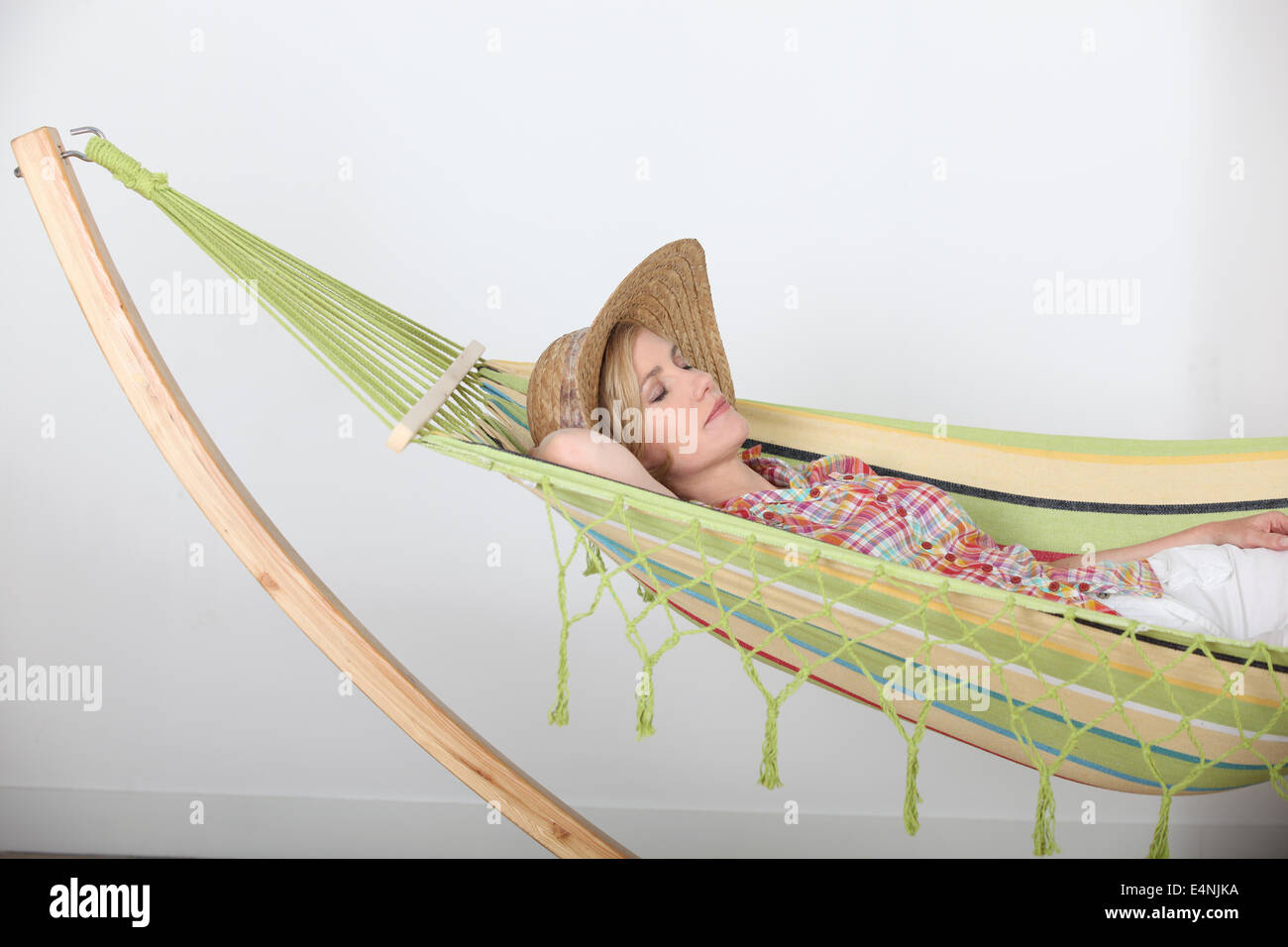 Woman lying relaxing in hammock Stock Photo - Alamy