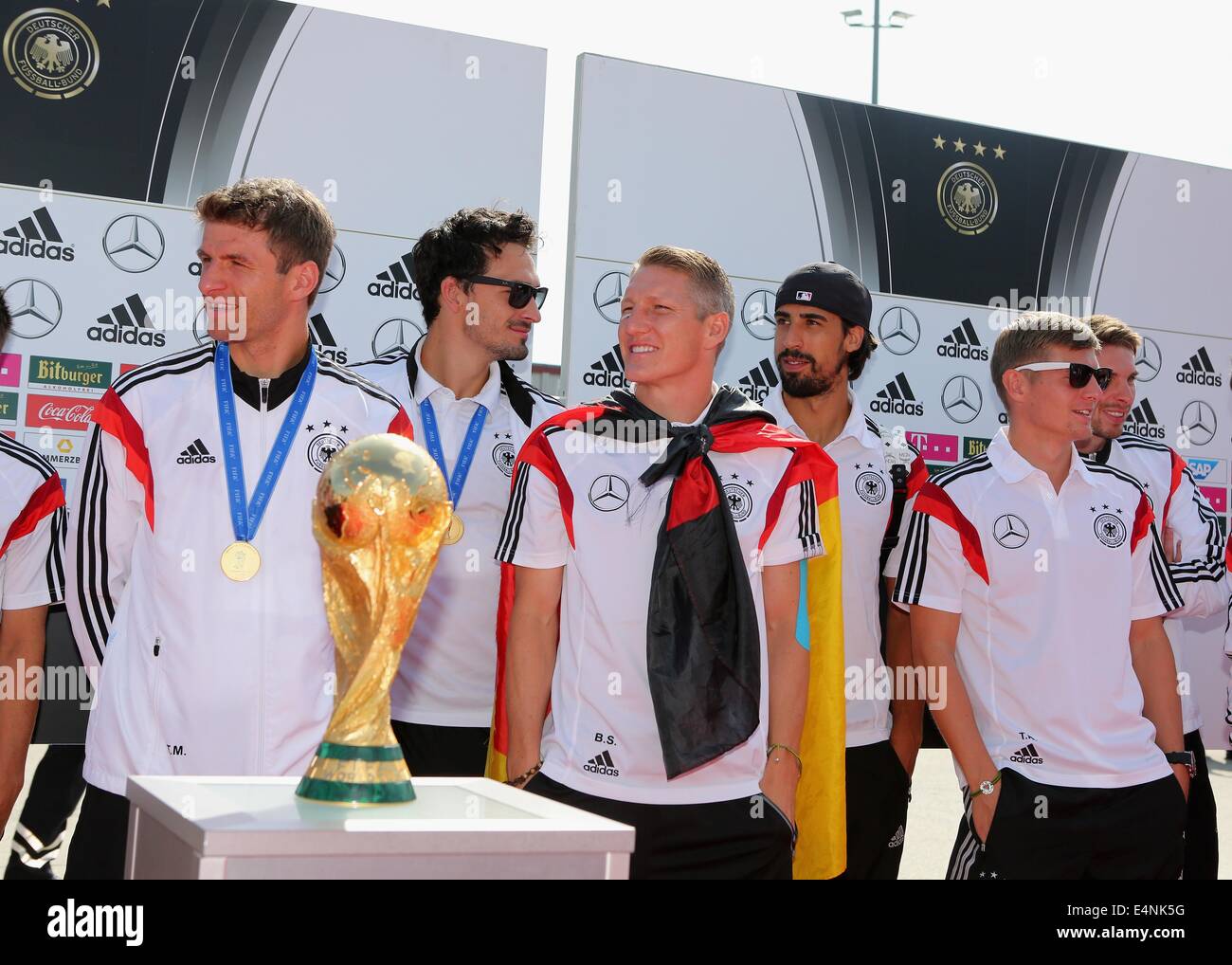 Berlin, Germany. 15th July, 2014. HANDOUT - A handout picture shows the German national soccer players Thomas Mueller (L-R), Mats Hummels, Bastian Schweinsteiger, Sami Khedira and Toni Kroos standing behind the World Cup trophy in Berlin, Germany, 15 July 2014. Photo:dpa/Alamy Live News/dpa/Alamy Live News Stock Photo
