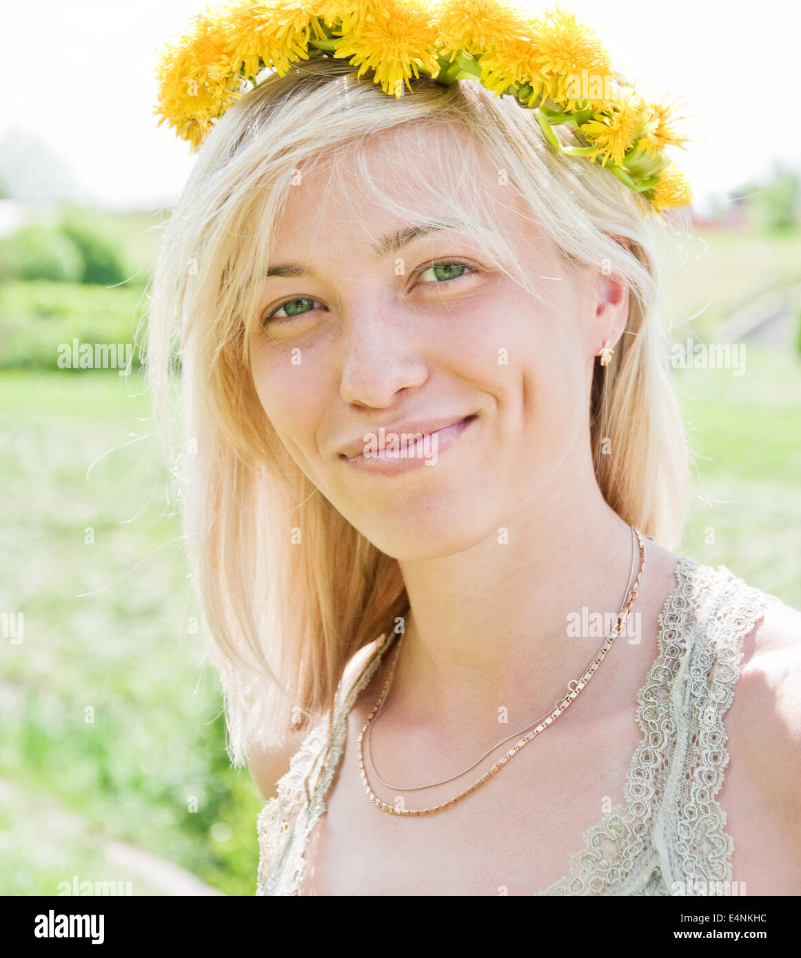 Portrait of a young girl with a wreath of dandelions Stock Photo - Alamy