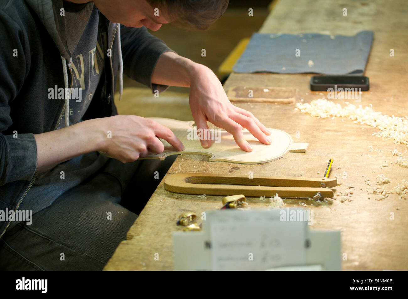 Young man making a violin at the Violin Cambridge Stock Photo