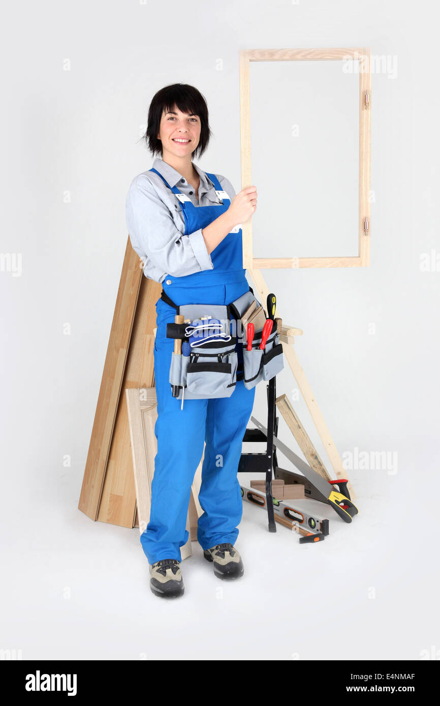 A carpenter holding up her handiwork Stock Photo