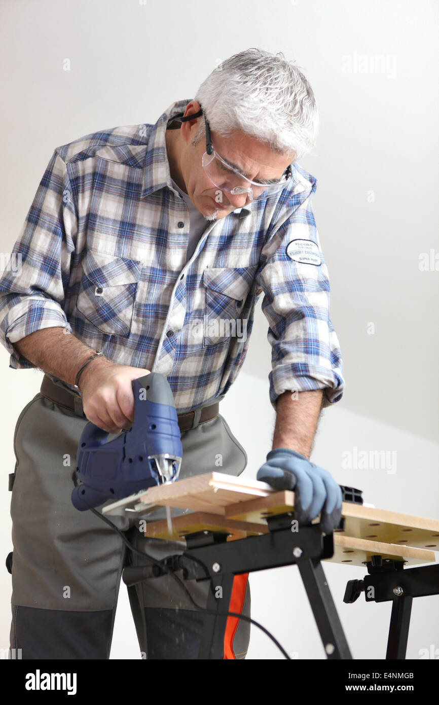 Tradesman using a jigsaw Stock Photo