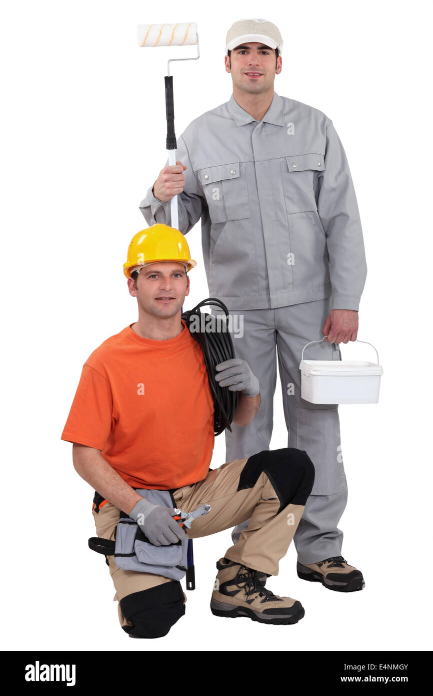 Electrician kneeling by painter Stock Photo