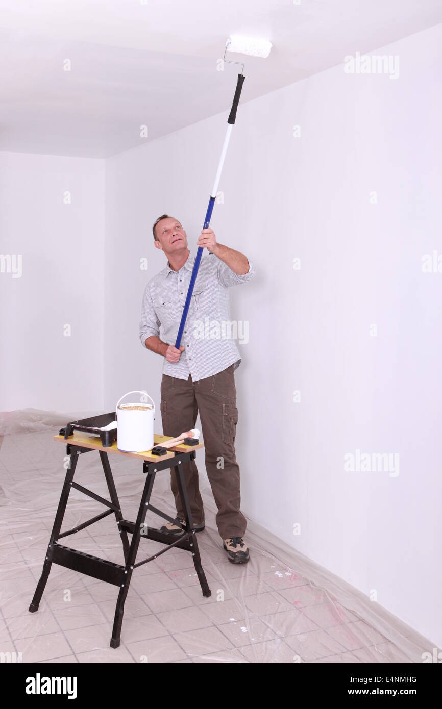 Laborer painting ceiling Stock Photo Alamy
