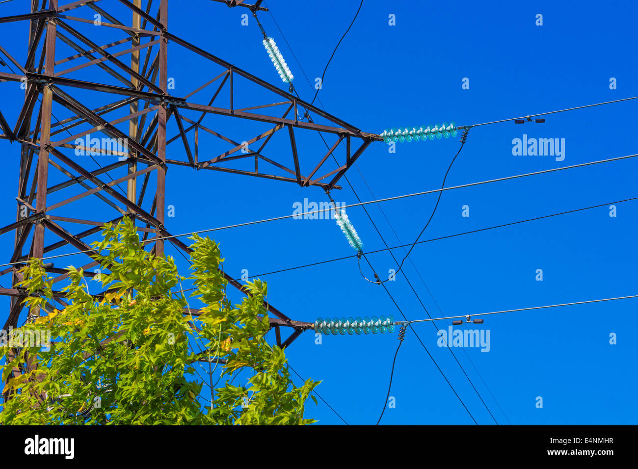 Fragment of high voltage power pylon against blue sky Stock Photo - Alamy