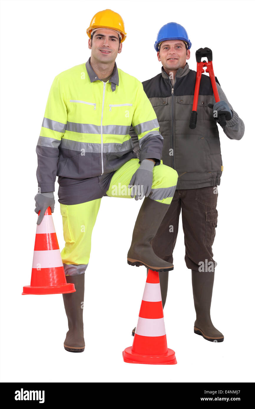 Two men stood with traffic cones Stock Photo