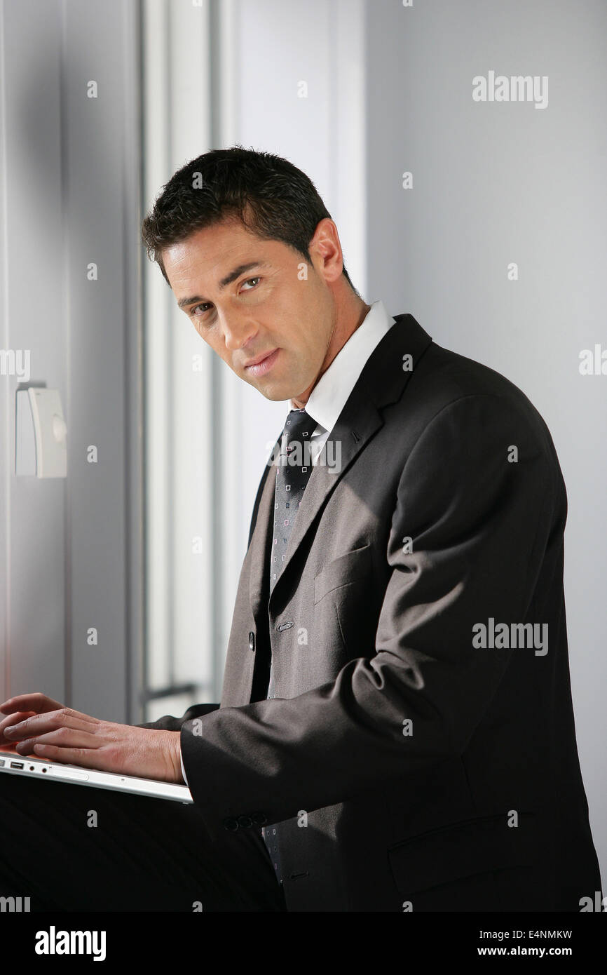 Confident businessman using a laptop Stock Photo