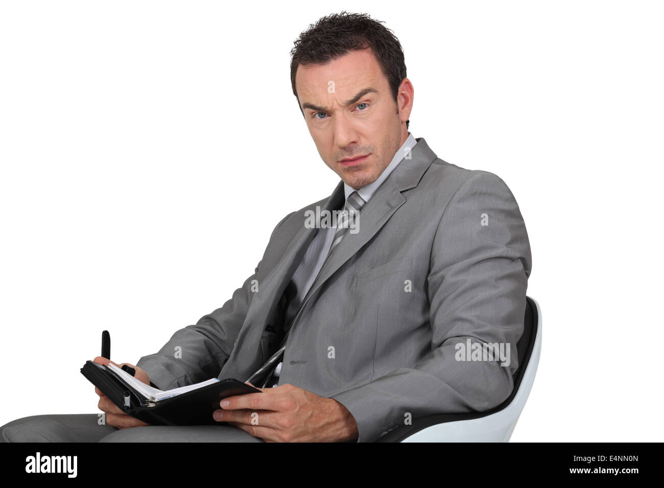 Man in suit writing in diary Stock Photo