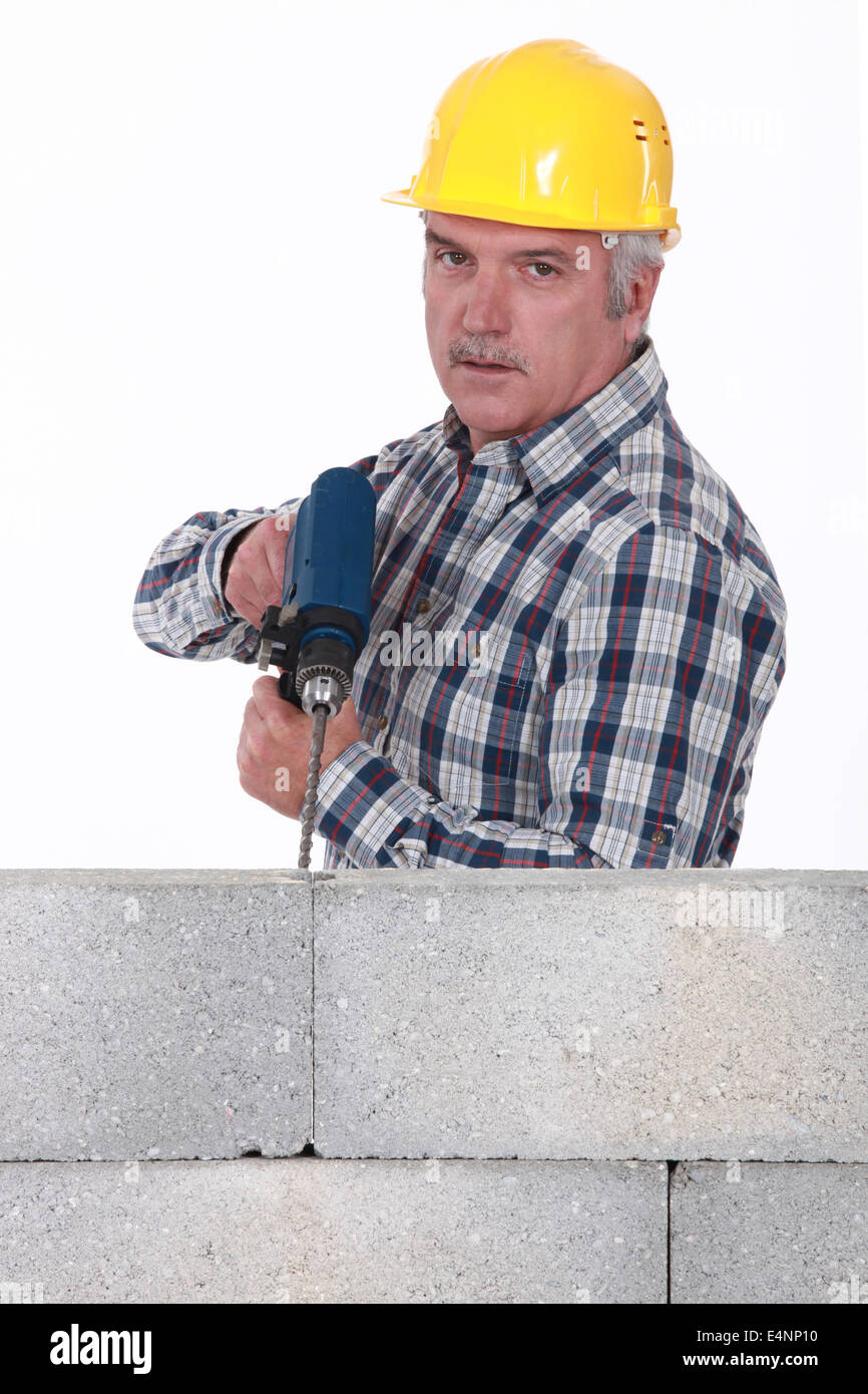 Tradesman using a power tool Stock Photo