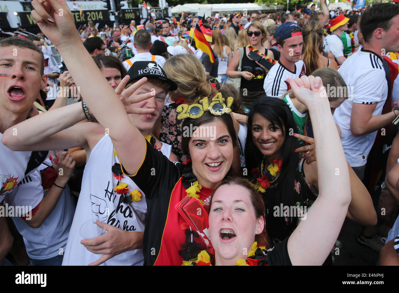 Berlin, Germany. 15th July, 2014. FAns celebrate at the reception of the German national team at the so-called 'Fan Meile' at Brandenburg Gate in Berlin, Germany, 15 July 2014. The German team on 13 July 2014 had won the Brazil 2014 FIFA Soccer World Cup final against Argentina by 1-0 to win the title for the fourth time after 1954, 1974 and 1990. Photo: KAY NIETFELD DPA/Alamy Live News Stock Photo