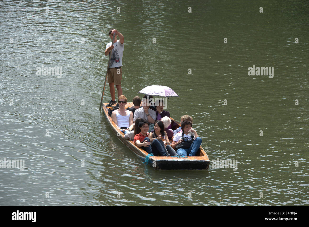 Cambridge, UK. 15th July,  2014. Tourists enjoy punting on the River Cam in a alternating sunshine and clouds. Temperatures are set to rise to the hottest of the year in the South East over the next 48 hours. The superstitious believe that if it rains today it will rain for the next 40 days. Credit Julian Eales/Alamy Live News Stock Photo
