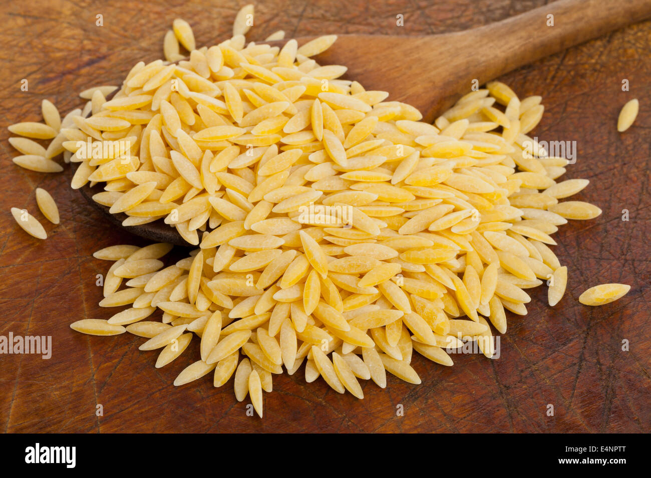Durum wheat, also hard wheat or macaroni wheat, on wooden spoon kitchen board Stock Photo