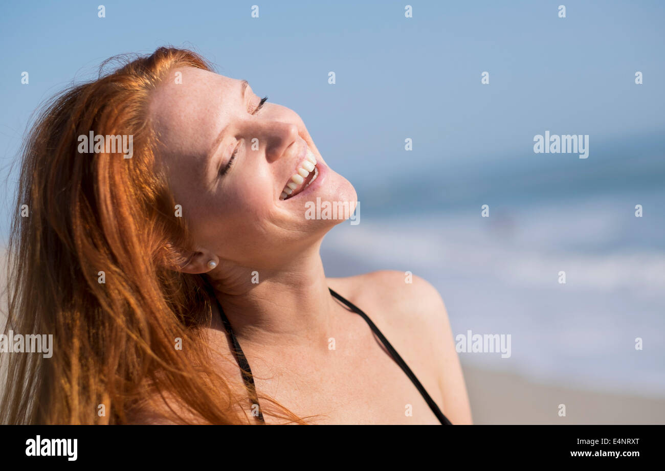 Woman on beach suntanning Stock Photo