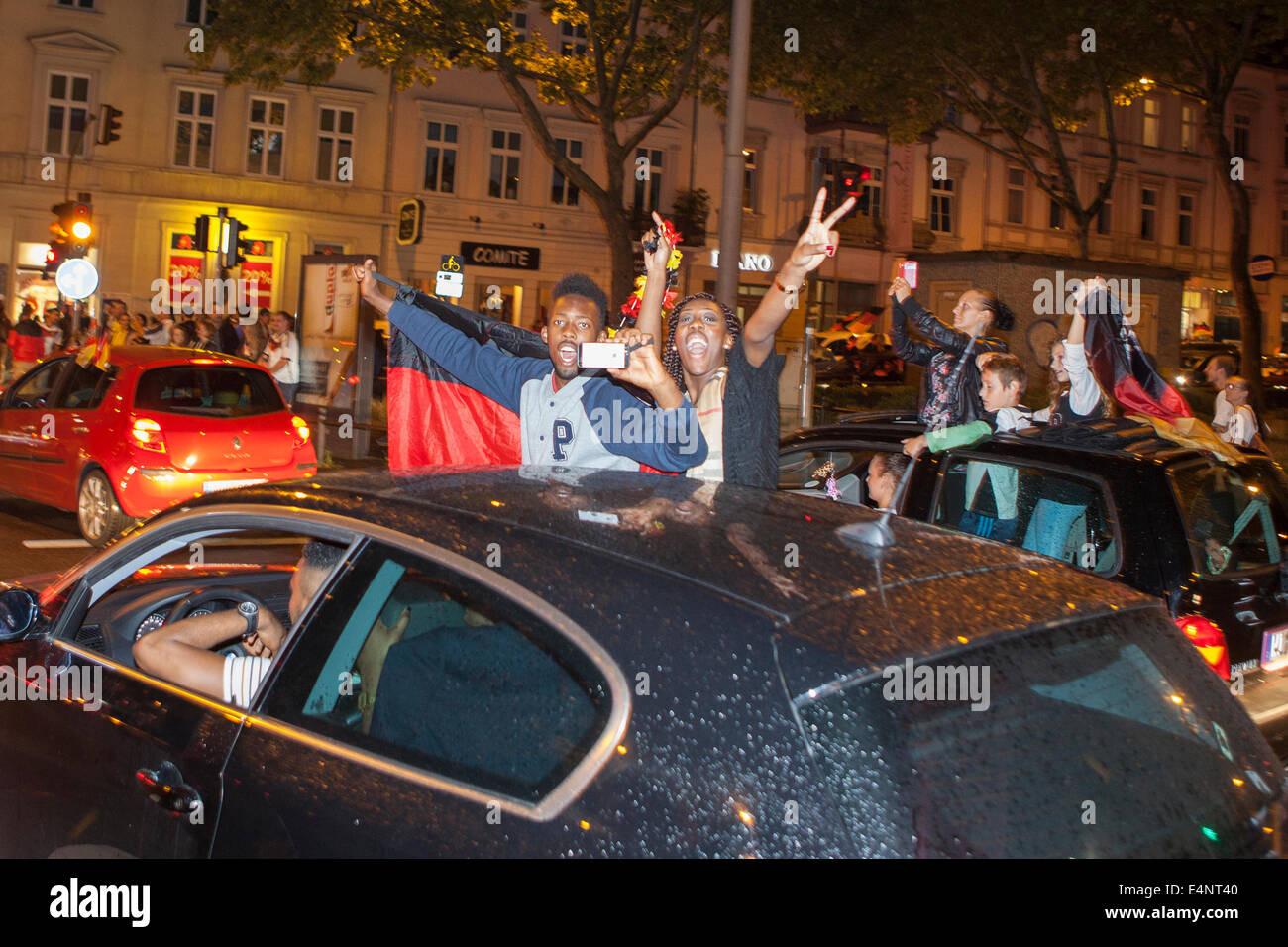 Wiesbaden, Germany. 14th July, 2014. Germany wins the FIFA World Cup 2014. People in their cars and on the street cheering and celebrating in downtown Wiesbaden after Germanys victory over Argentina in the final match. Some motion blur. Credit:  Oliver Kessler/Alamy Live News Stock Photo