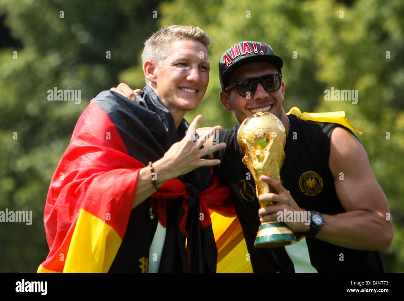 Berlin, Germany. 15th July, 2014. German football players Lukas Podolski (R) and Bastian Schweinsteiger pose during celebration to mark the team's 2014 Brazil World Cup victory in Berlin, Germany, July 15, 2014. Germany's team returned home on Tuesday after winning the 2014 Brazil World Cup. Credit:  Zhang Fan/Xinhua/Alamy Live News Stock Photo