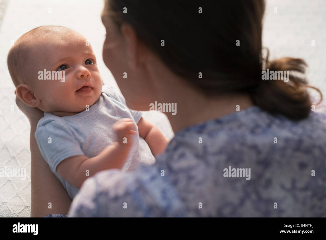 Mother holding baby boy (2-5 months) Stock Photo