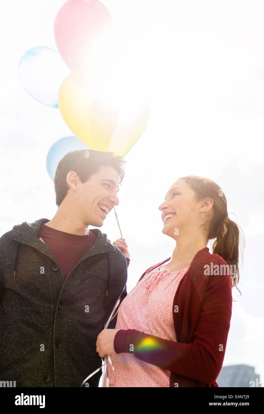 Young couple with balloons Stock Photo - Alamy