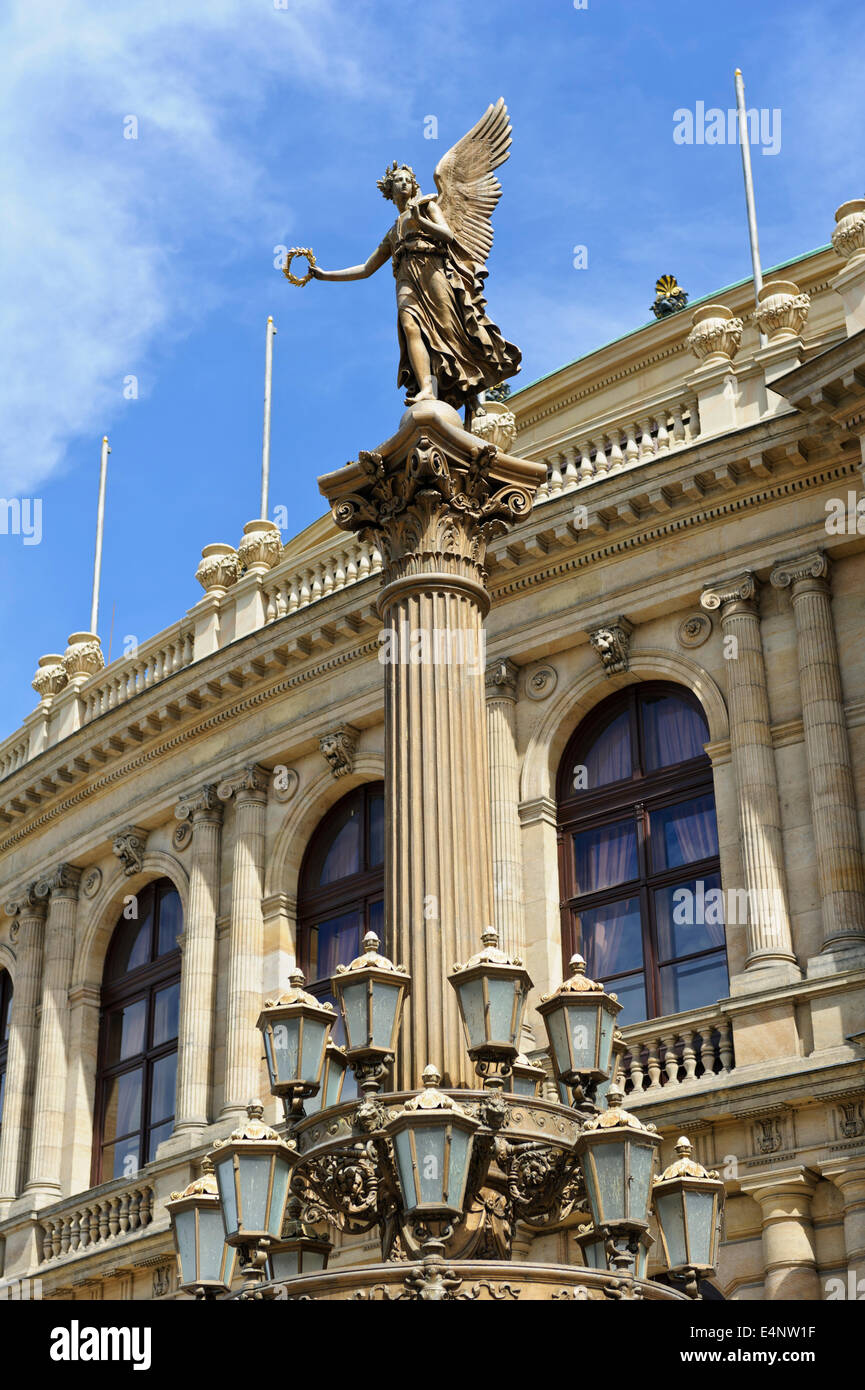 A classical lighting column with an angel statue outside the Rudolfinum ...
