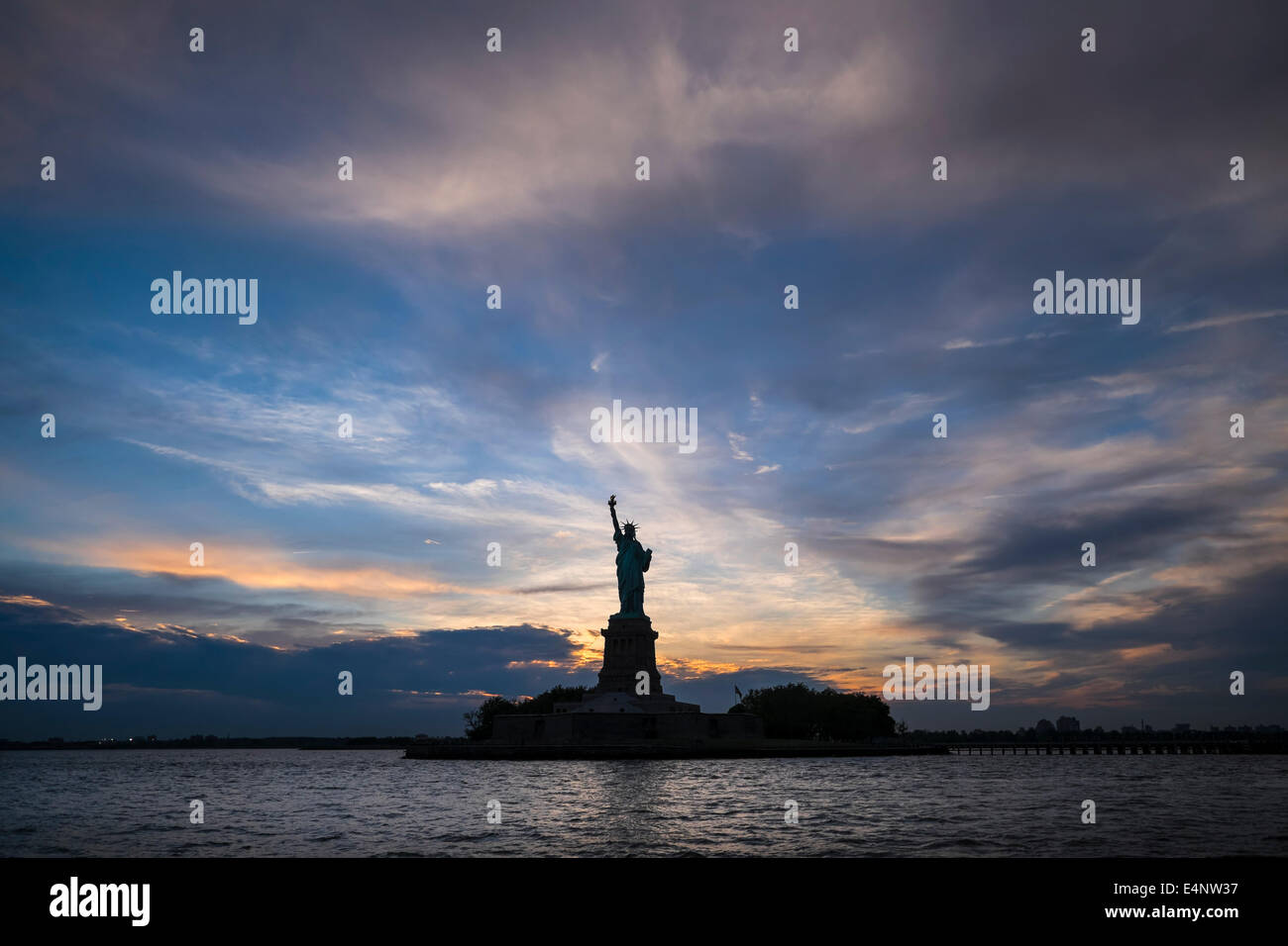 USA, New York, New York City, Silhouette of Statue of Liberty at sunset ...