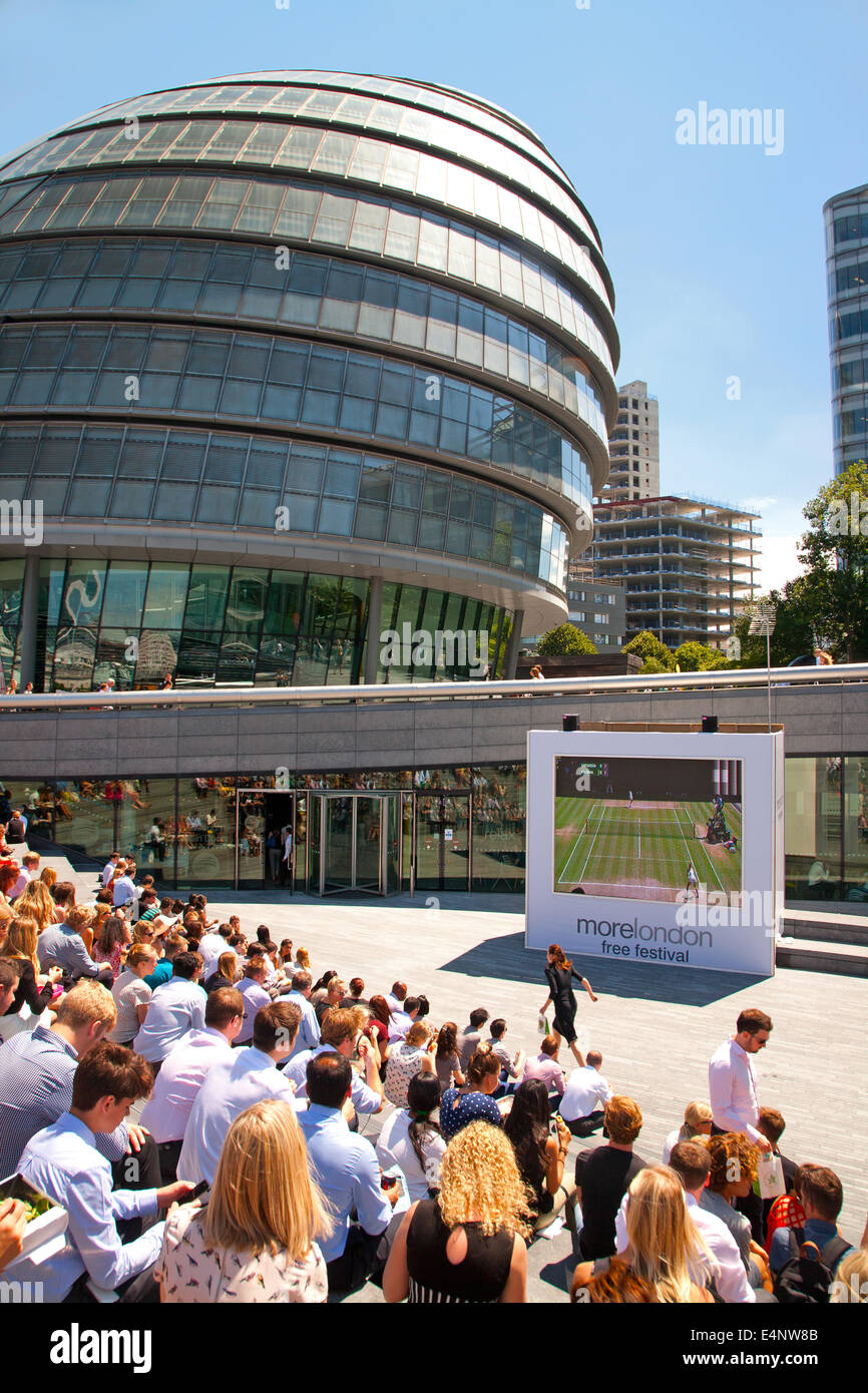 Wimbledon fans gather to watch live tennis on a giant LCD screen as part of the More London free festival,Centre Court,London,UK Stock Photo