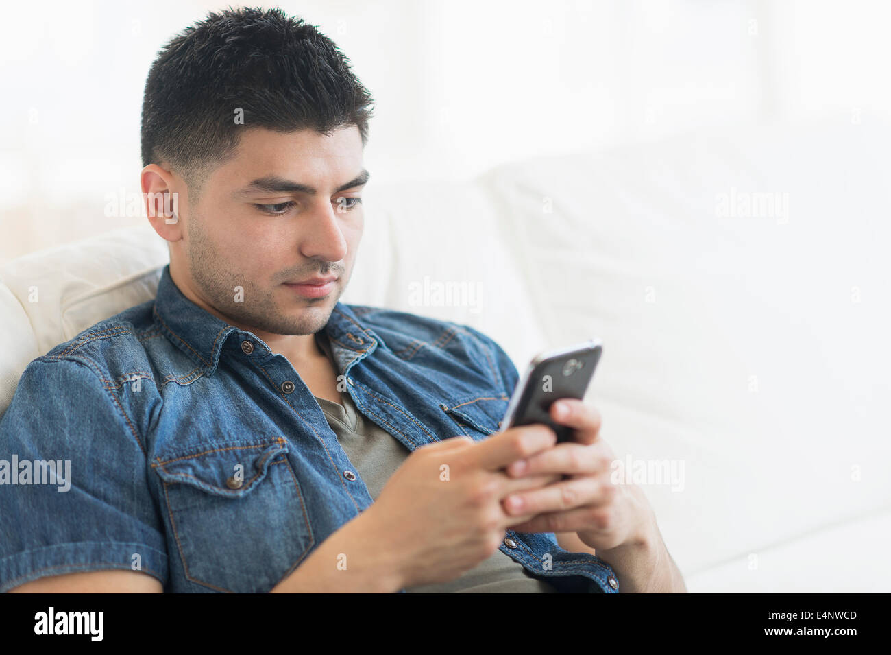 Young man using mobile phone Stock Photo