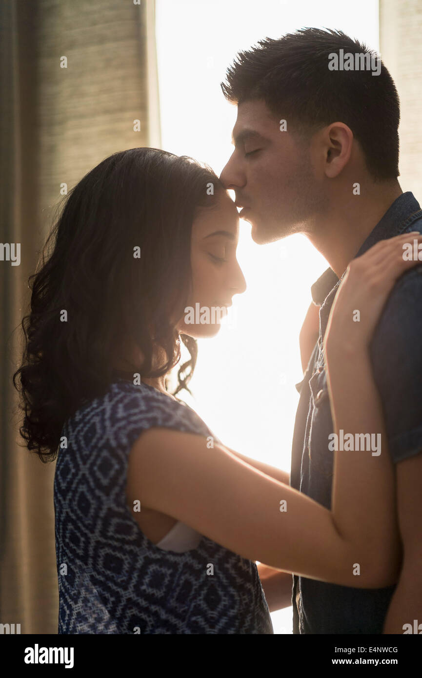 Young couple kissing in sunlight Stock Photo