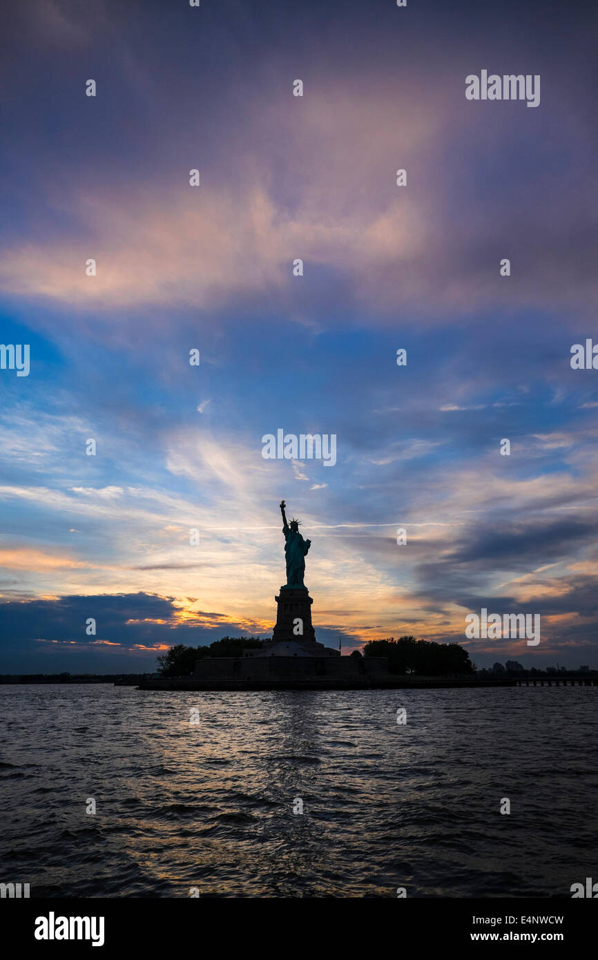 USA, New York, New York City, Silhouette of Statue of Liberty at sunset ...