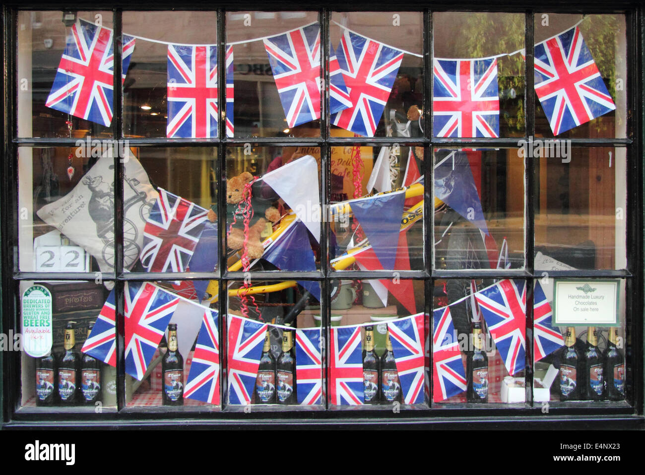 Union Jack bunting displayed in the window of The Old Original Bakewell Pudding Shop, Bakewell, Peak District, England, UK Stock Photo
