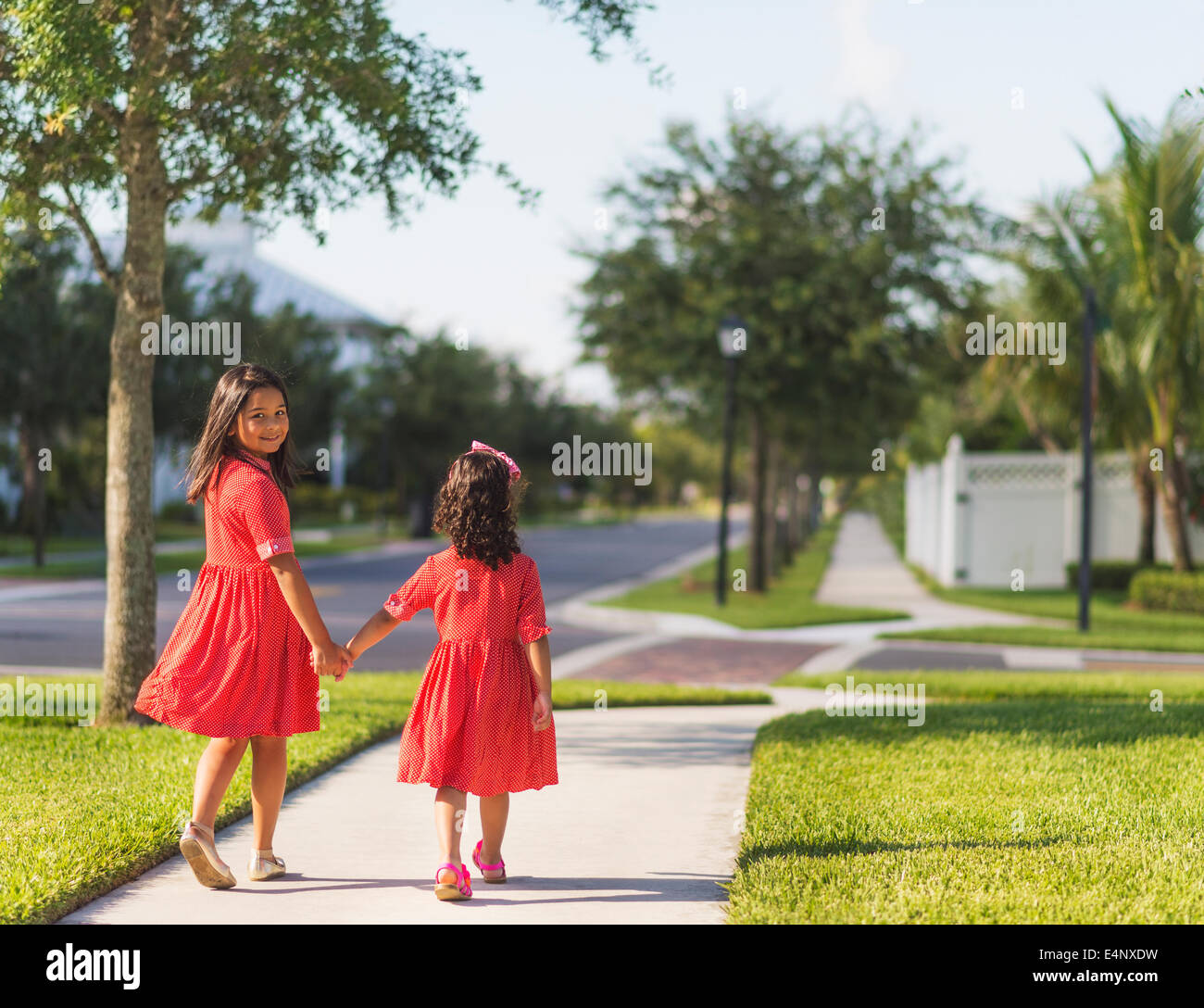 USA, Florida, Jupiter, Back view of girls (4-5, 8-9) holding hands Stock Photo